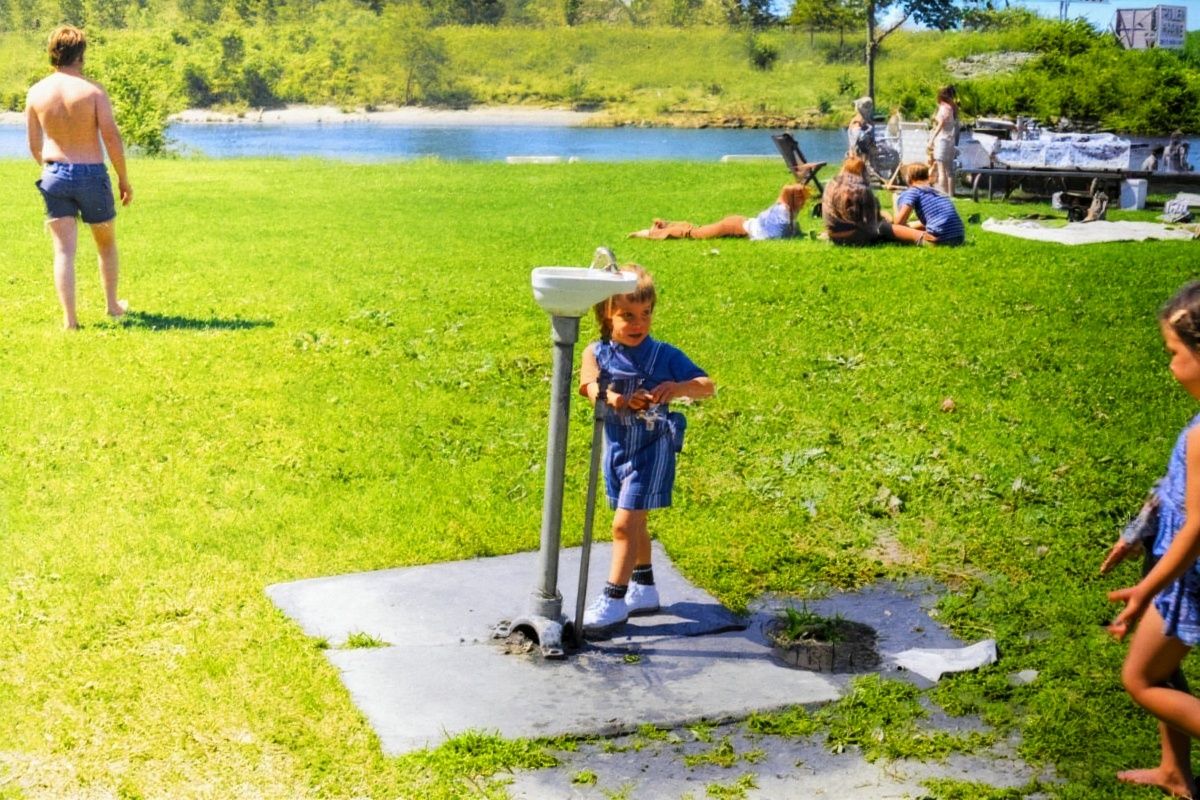 The same park in colour, the grass green and the river blue